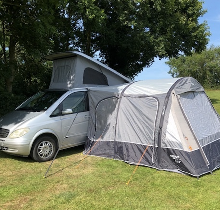 Campervan equipment | Campervan parked up with awning attached to the side. 