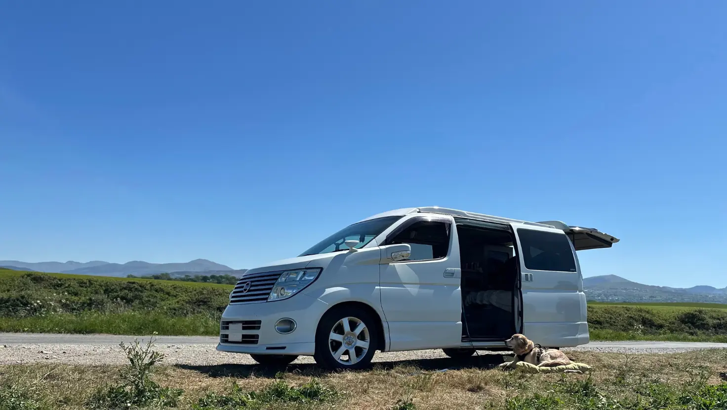 white campervan parked on a rural quiet road