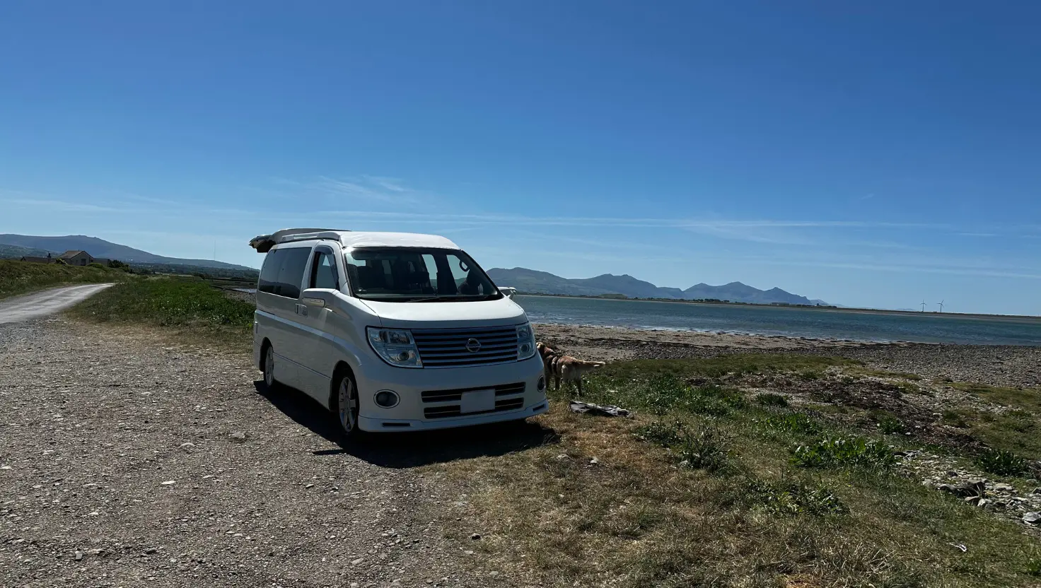 campervan parked by a remote coastline