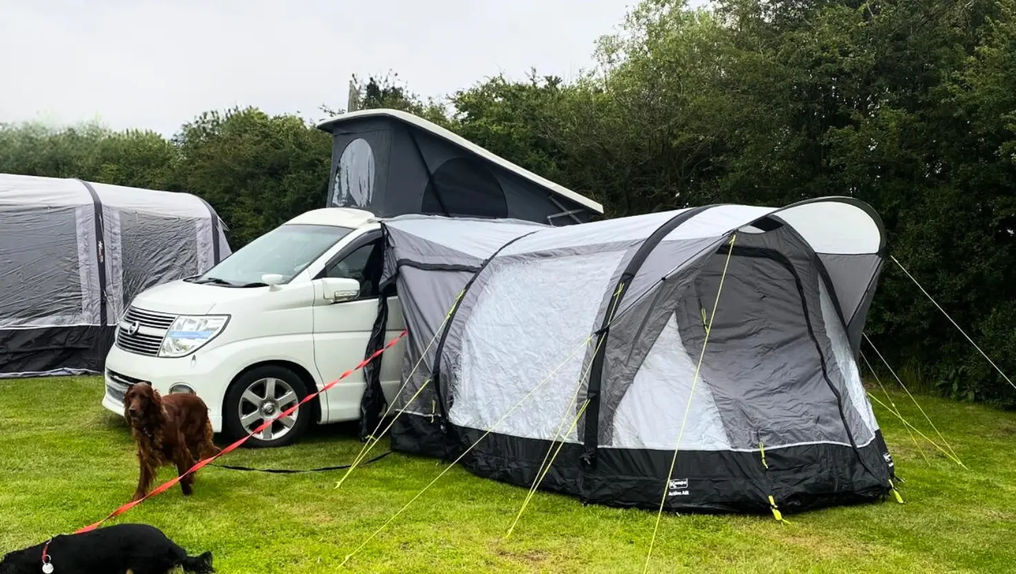white campervan with an awning attached