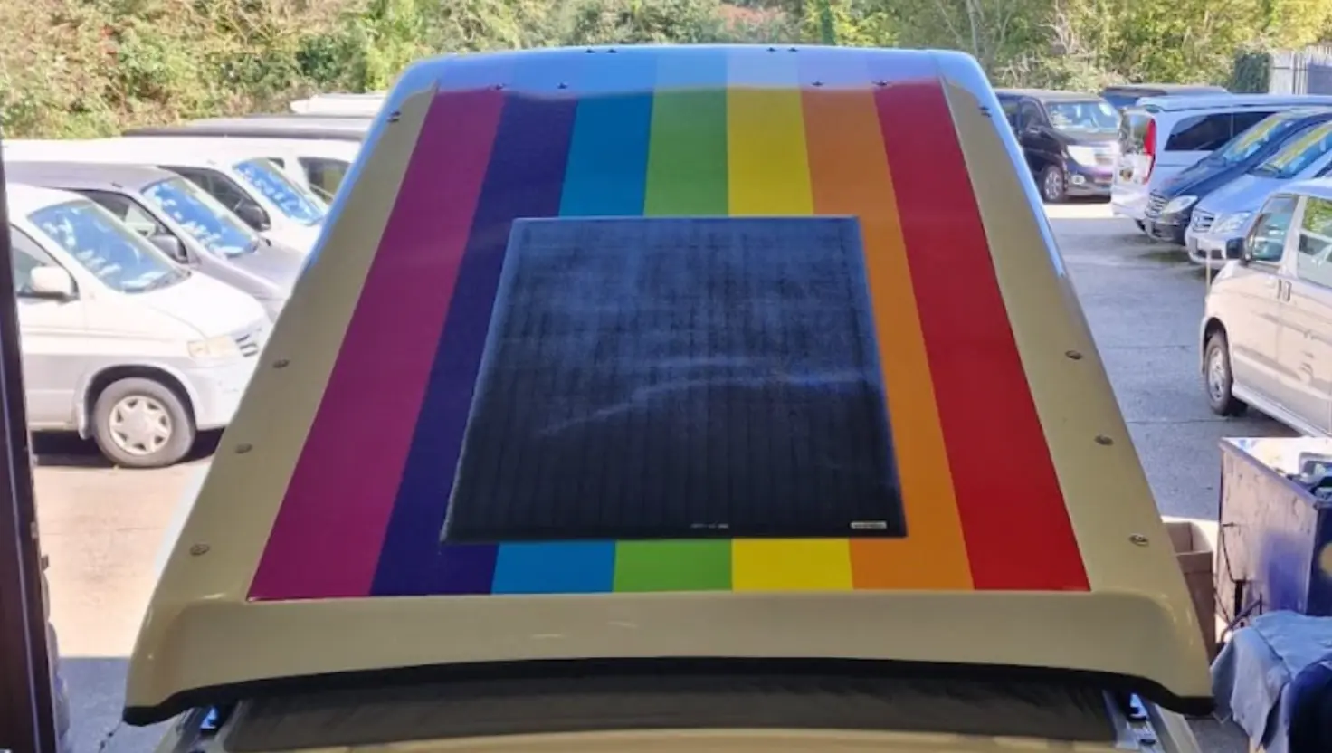 rainbow on the pop top roof of a campervan for LGBTQ+ campervan travel