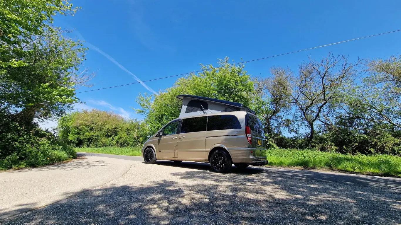 compact campervans on a country lane