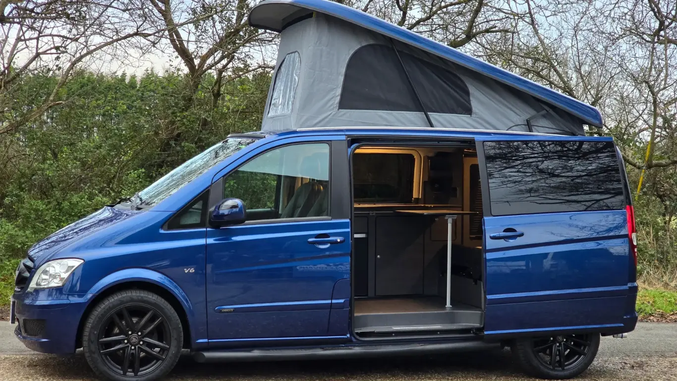 best campervan in blue with pop top roof up and side door open
