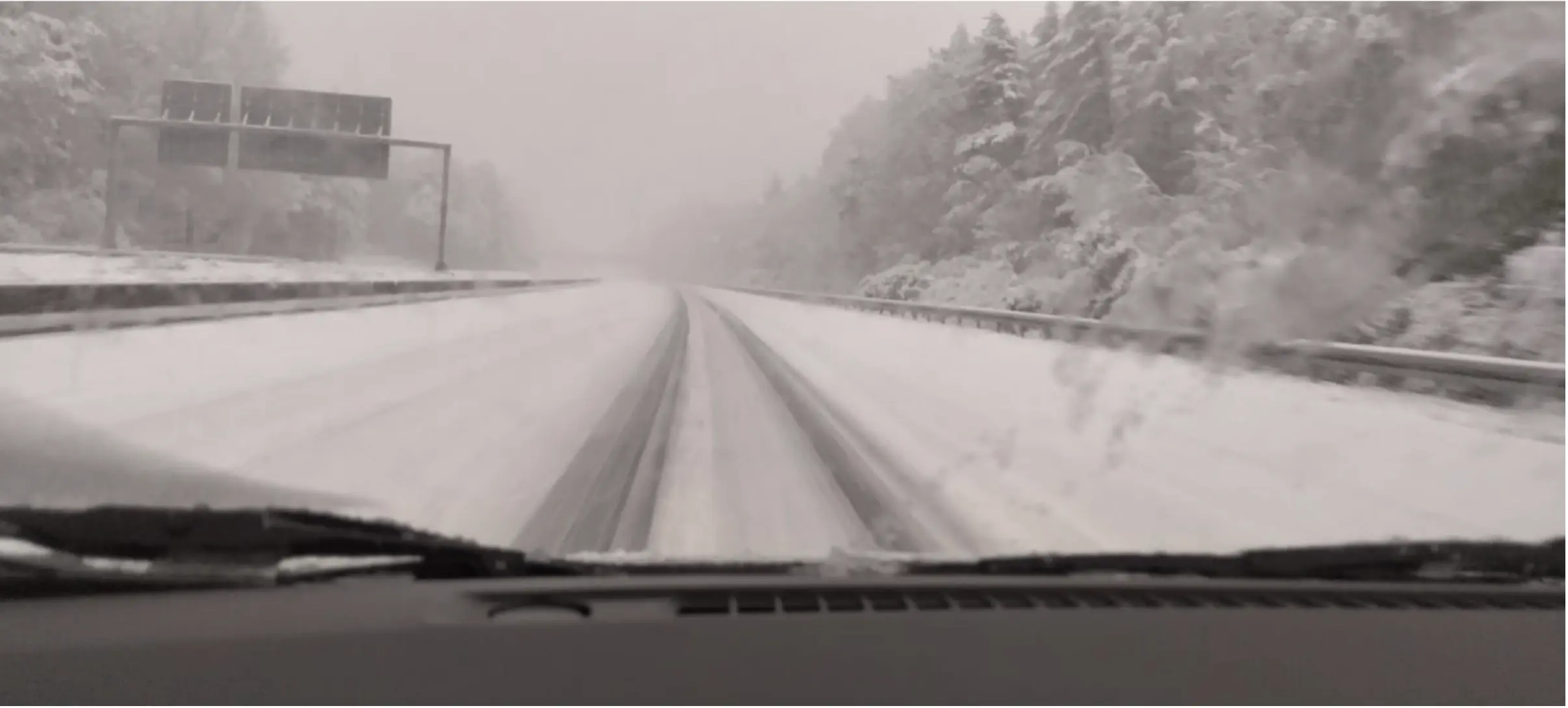 snow on road with tyre tracks